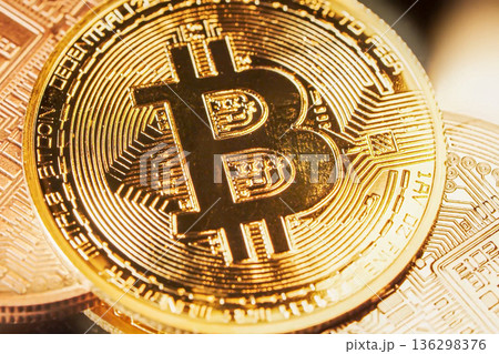 A close view of a bitcoin coin shows its design and texture. The gold-colored coin represents cryptocurrency valuable for trade and investment. It plays an important role in the digital economy. High A close view of a bitcoin coin shows its design and texture. The gold-colored coin represents cryptocurrency valuable for trade and investment. It plays an important role in the digital economy. High 136298376