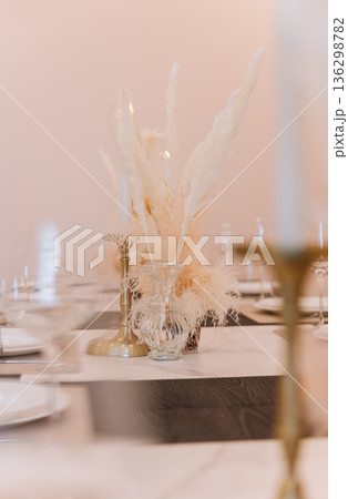 Soft focus pampas centerpiece and candle on elegant table setting, copy space Soft focus pampas centerpiece and candle on elegant table setting, copy space 136298782