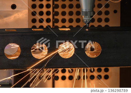 Close Up Fiber Laser Cutting and Engraving Square Tube Parts with Sparks in Industrial Manufacturing Close Up Fiber Laser Cutting and Engraving Square Tube Parts with Sparks in Industrial Manufacturing 136298789