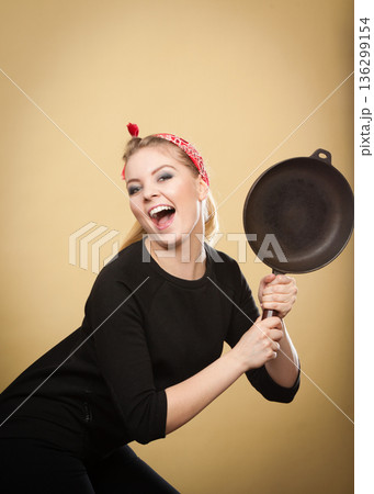 Retro styled woman having fun with kitchen accessories. 136299154
