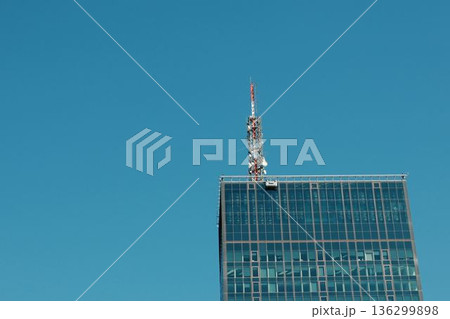Modern glass skyscraper in Belgrade with antenna and clear sky Modern glass skyscraper in Belgrade with antenna and clear sky 136299898