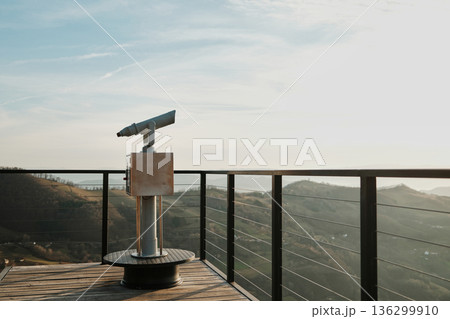 Observation telescope on a viewing platform overlooking rolling hills and valleys in Tara National Park Serbia. Concept of sightseeing travel discovery nature tourism and exploration 136299910