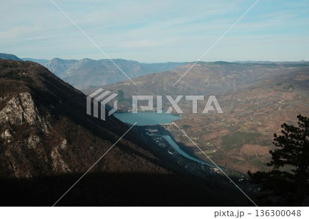 Panoramic view of Perucac Lake and Drina River surrounded by mountains and forests in western Serbia. Natural reservoir landscape with dam and rural settlements 136300048