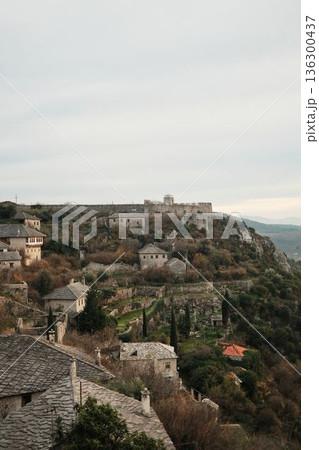Wide view of Pocitelj Fortress with stone houses and terraced gardens on the hillside above the Neretva River, showing preserved medieval village architecture in Bosnia and Herzegovina 136300437