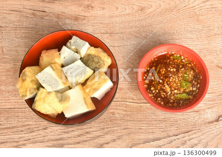 soft fried Japanese tofu dipping with sweet crushed bean sauce on bowl 136300499