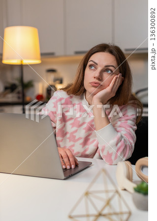 Adult woman irritated by workload waves hand on laptop ends late shift plans new start tomorrow 136300892