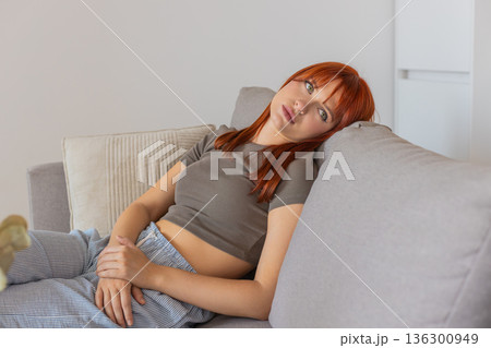 Young woman feels drained in bad mood after harsh news so low energy stare deep sigh and slow slump Young woman feels drained in bad mood after harsh news so low energy stare deep sigh and slow slump 136300949