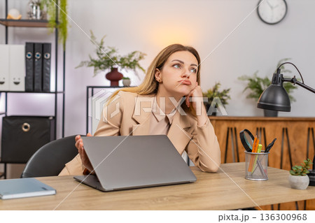Businesswoman shuts laptop tired look waves hand annoyed by boring job after long shift frustrated 136300968