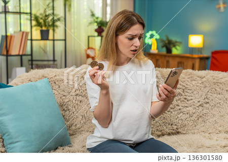 Pregnant woman checks bitcoin chart on smartphone sees big fall presses phone to head plans finance Pregnant woman checks bitcoin chart on smartphone sees big fall presses phone to head plans finance 136301580