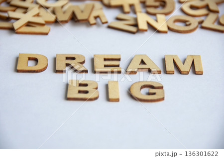 Dream big text made of wooden letters on white background symbolizing ambition motivation mindset and personal growth concept. 136301622