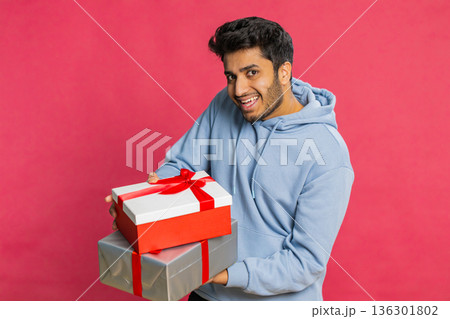 Smiling man presenting birthday gift present box stretches out hands, promotion discount sale Smiling man presenting birthday gift present box stretches out hands, promotion discount sale 136301802
