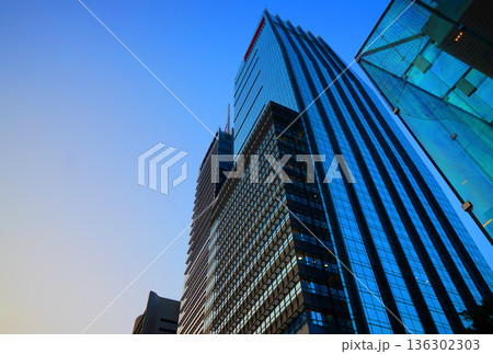 Skyscrapers towers building on sunset background Skyscrapers towers building on sunset background 136302303