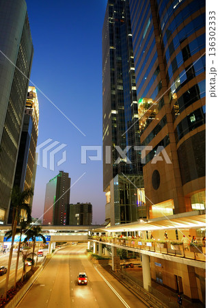Traffic scene in night urban life. Skyscrapers modern buildings. Hong Kong business towers. Traffic scene in night urban life. Skyscrapers modern buildings. Hong Kong business towers. 136302333