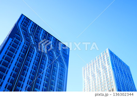 Glass building in sunset. Facade of new modern business office building. Glass building facade 136302344