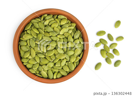Peeled pumpkin seeds in ceramic bowl isolated on white background. Top view. Flat lay Peeled pumpkin seeds in ceramic bowl isolated on white background. Top view. Flat lay 136302448