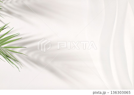 Premium empty podium with shadows of tropical palm leaves on sunny wall, minimal abstract background for cosmetics product presentation, design template, podium on pedestal, selective focus. 136303065