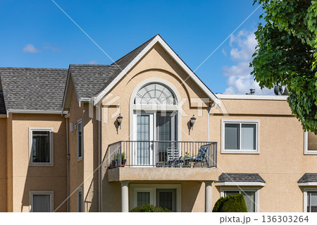 Contemporary Residential Buildings with Modern Balcony Brick Facade Under a Clear blue Sky 136303264