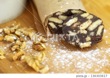 Chocolate salami sausage on a wooden board 136303617