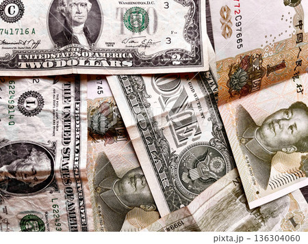 mixed US dollar and Chinese yuan banknotes symbolizing global finance, currency exchange, economic competition, international trade, inflation pressure, and shifting balance of world economies mixed US dollar and Chinese yuan banknotes symbolizing global finance, currency exchange, economic competition, international trade, inflation pressure, and shifting balance of world economies 136304060
