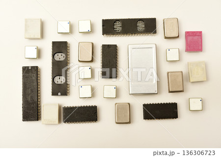 Old chips on a white background. Electronic components. Processors in metal and plastic cases. 136306723