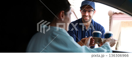 Hand Man in car receiving coffee in drive thru fast food restaurant. Hand Man in car receiving coffee in drive thru fast food restaurant. 136306966