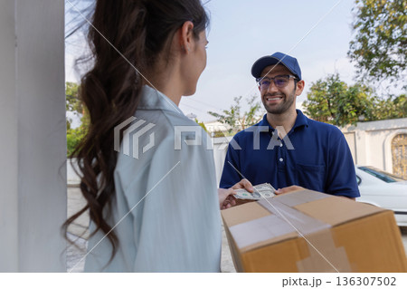 Delivery express courier young man use giving boxes or Food to woman customer  at front home.  136307502