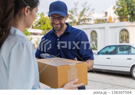 Delivery express courier young man use giving boxes or Food to woman customer  at front home.  136307504