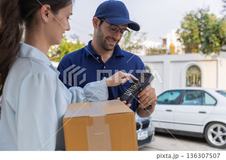 Delivery express courier young man use giving boxes or Food to woman customer  at front home.  136307507
