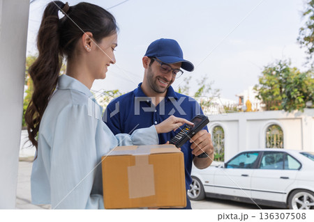 Delivery express courier young man use giving boxes or Food to woman customer  at front home.  136307508