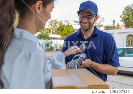 Delivery express courier young man use giving boxes or Food to woman customer at front home. Delivery express courier young man use giving boxes or Food to woman customer at front home. 136307526
