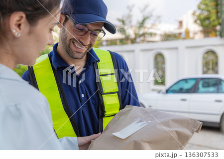 Delivery express courier young man use giving boxes or Food to woman customer at front home. Delivery express courier young man use giving boxes or Food to woman customer at front home. 136307533