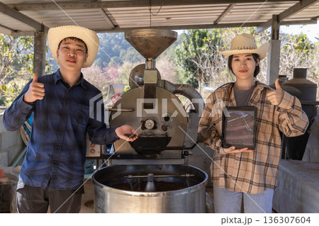 Coffee processing. Coffee roasting machine with arabica beans in stainless steel cooling bin. Coffee processing. Coffee roasting machine with arabica beans in stainless steel cooling bin. 136307604