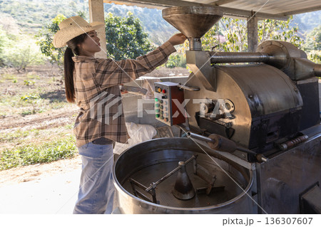Coffee processing. Coffee roasting machine with arabica beans in stainless steel cooling bin. Coffee processing. Coffee roasting machine with arabica beans in stainless steel cooling bin. 136307607