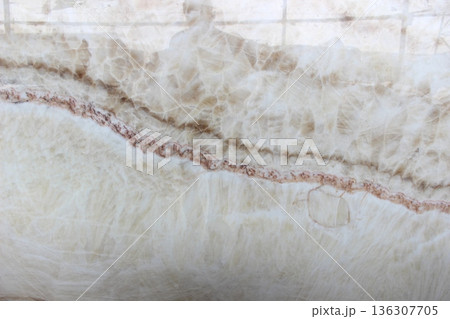 White Onyx stone texture with reddish brown veins featuring translucent properties and a beautiful crystalline appearance. 136307705