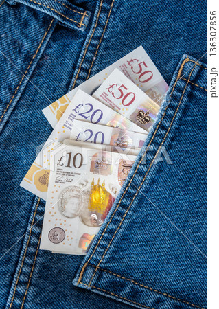 Jeans with british pound money. United Kindom bills in the pants pocket for commerce concept. Jeans with british pound money. United Kindom bills in the pants pocket for commerce concept. 136307856