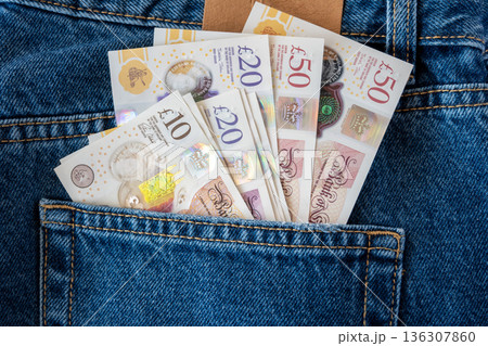 Jeans with british pound money. United Kindom bills in the pants pocket for commerce concept. Jeans with british pound money. United Kindom bills in the pants pocket for commerce concept. 136307860