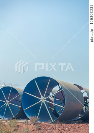 Steel Large diameter pipes are stacked in an industrial factory at construction site. Steel Large diameter pipes are stacked in an industrial factory at construction site. 136308333