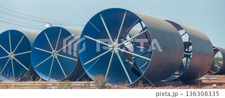 Steel Large diameter pipes are stacked in an industrial factory at construction site. Steel Large diameter pipes are stacked in an industrial factory at construction site. 136308335