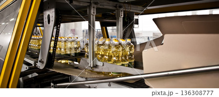 Automated packaging line for sunflower oil in a modern factory 136308777