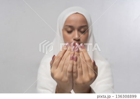 Relaxed individual in peaceful meditation setting with textured rug 136308899