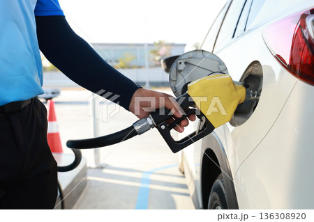 Man Refill and filling Oil Gas Fuel at station. Gas station - refueling. 136308920