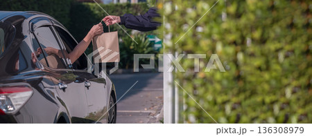 Hand Man in car receiving coffee in drive thru fast food restaurant. Hand Man in car receiving coffee in drive thru fast food restaurant. 136308979