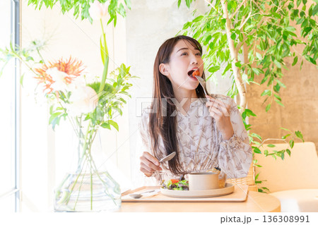 カフェでランチを食べている若い女性 136308991