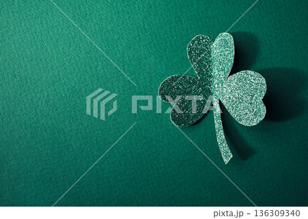 Glittering shamrock on green background, symbolizing luck and irish culture 136309340