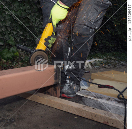 Construction worker in protective mask and gloves welding a steel beam outdoor Construction worker in protective mask and gloves welding a steel beam outdoor 136309417