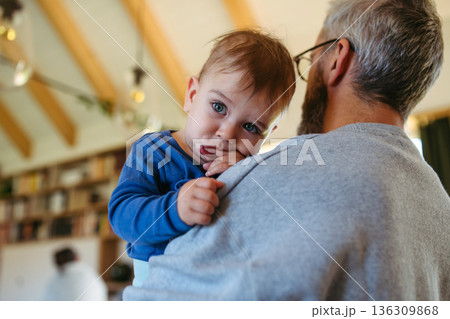 Dad comforting ill child with flu symptoms. Dad comforting ill child with flu symptoms. 136309868