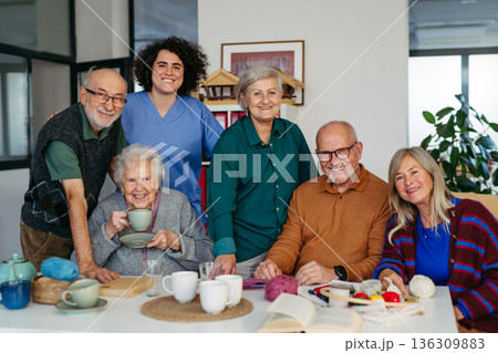 Nurse and group of elderly patients spending time together in community center. Nurse and group of elderly patients spending time together in community center. 136309883