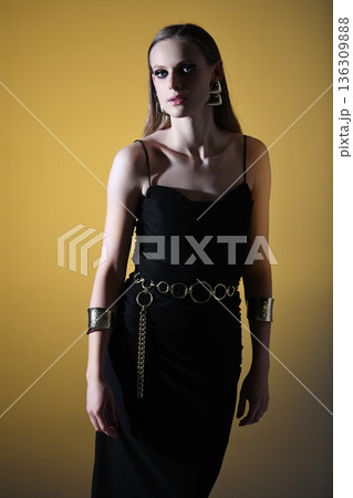 Woman posing in elegant black dress and fashion jewelry 136309888