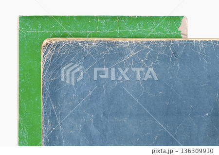 Stacked worn book cover surfaces with cracked paper texture and visible binding edges isolated on white background. Natural background for book cover design, book cover layout, print media template 136309910