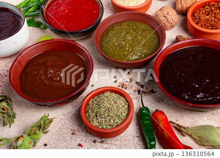 assortment of Georgian sauces and spices, top view, set of spices and tkemali, Georgian, food background, 136310564